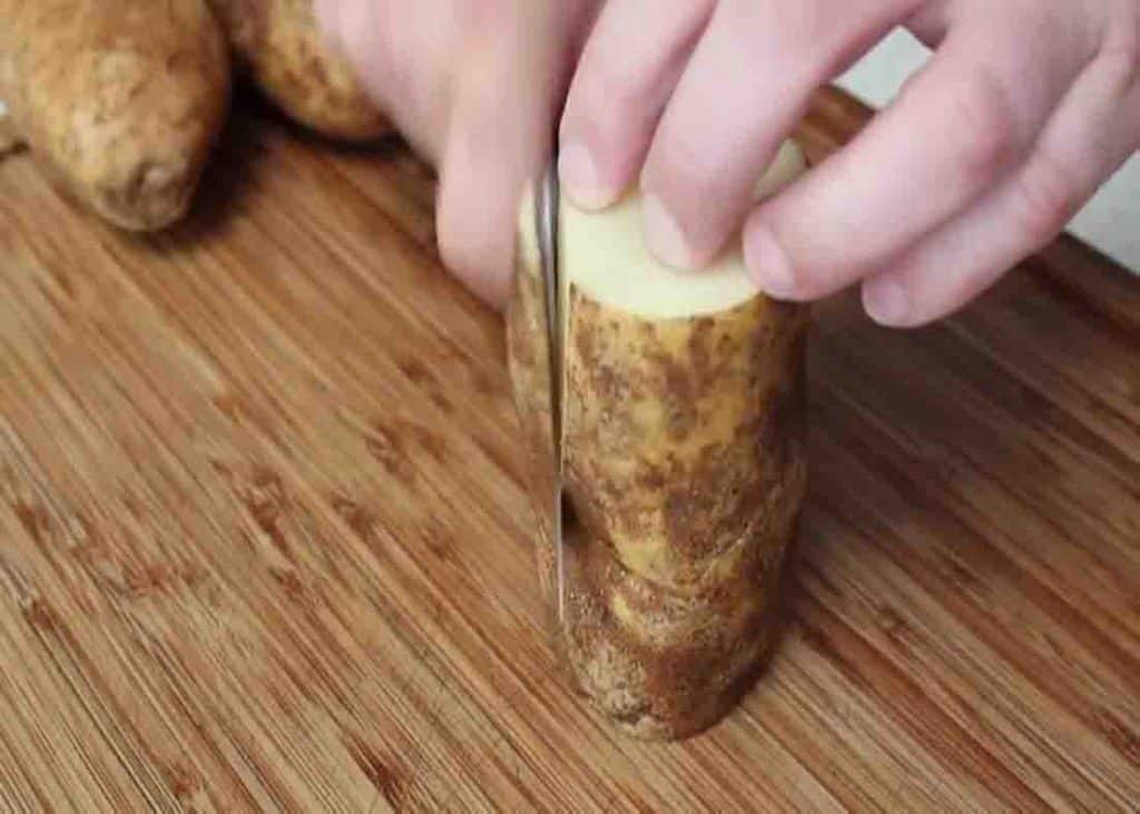 Cutting the potatoes and peeling them for the fondant potatoes recipe