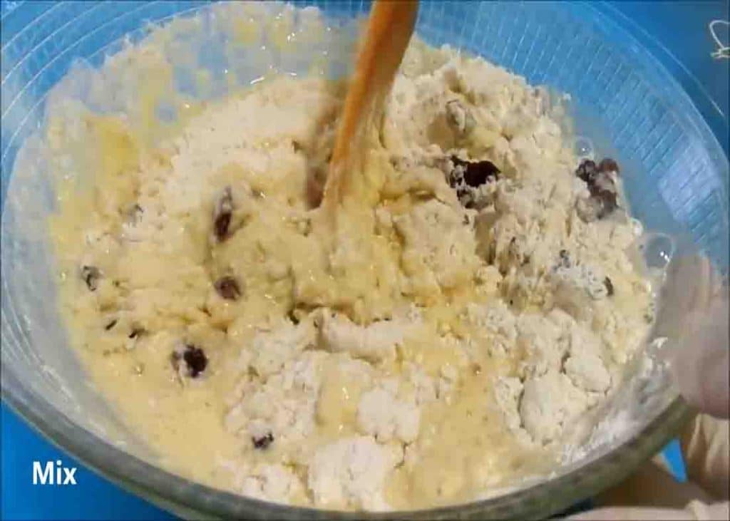 Mixing the dough mixture for the raisin bread rolls