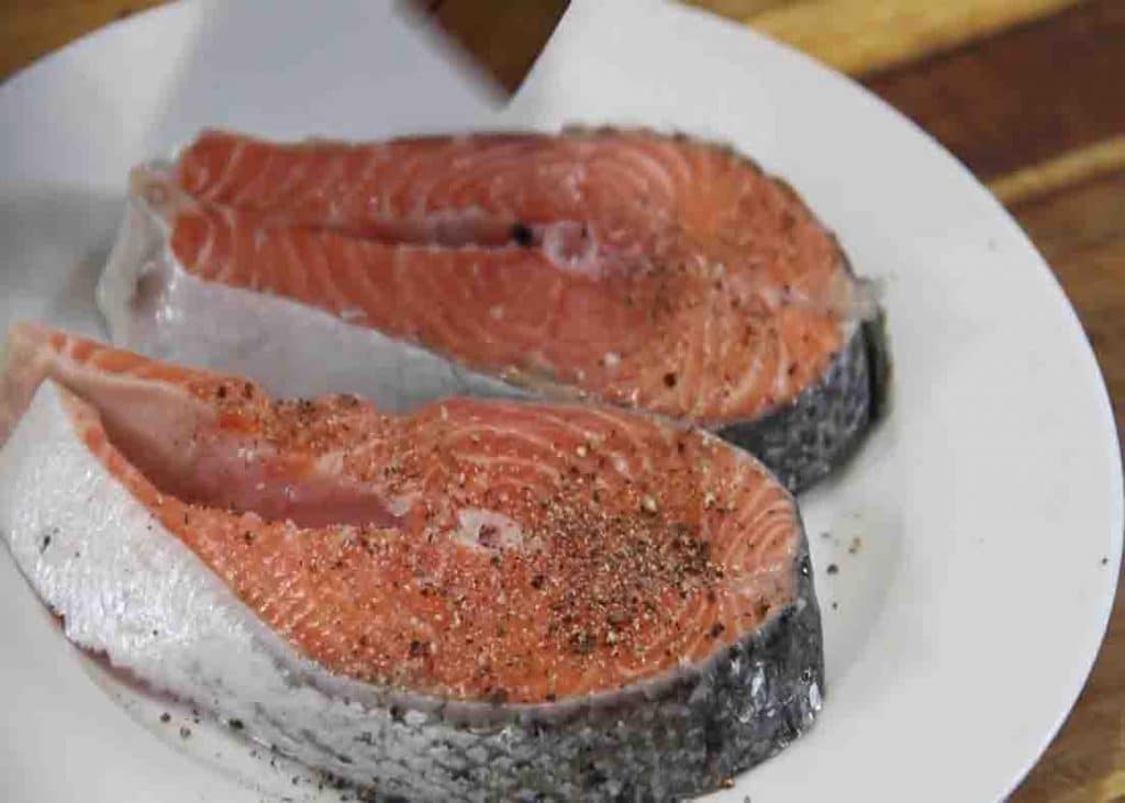 Seasoning the salmon on both sides