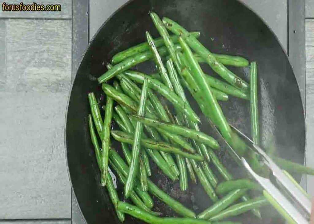 Sauteing the green beans in olive oil