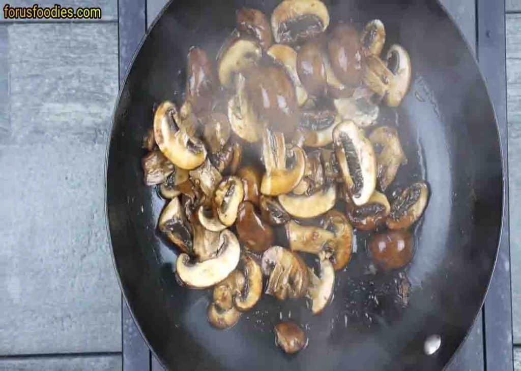 Sauteing the mushrooms with soy sauce