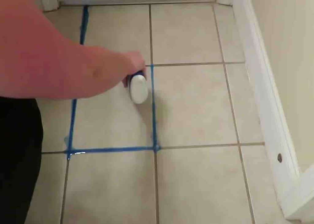 Applying Lysol toilet bowl cleaner to the grout