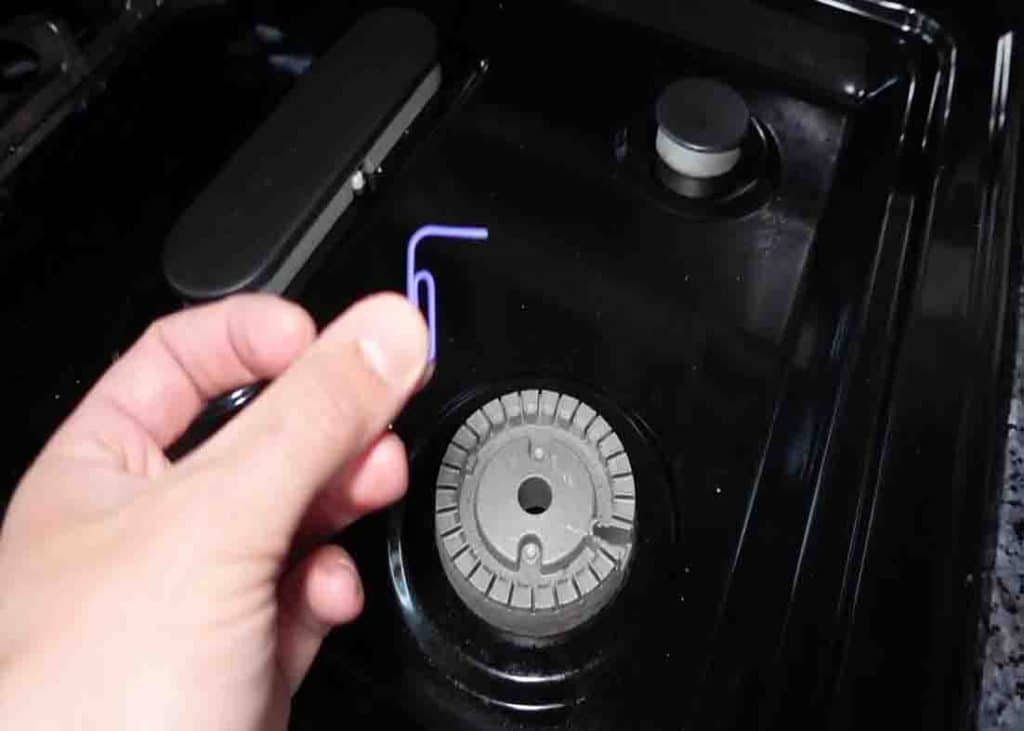 Use a small paper clip to remove any food particles that blocks the hole where the igniter goes through