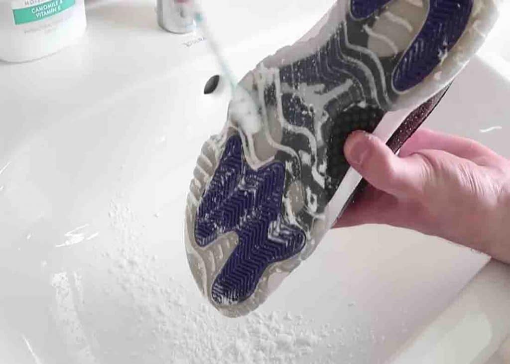 Brushing the soles form dried-up bicarbonate mixture