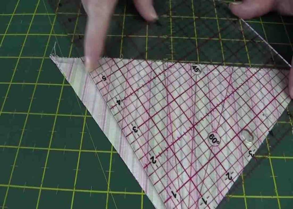 Squaring up a half square triangle with a straight ruler