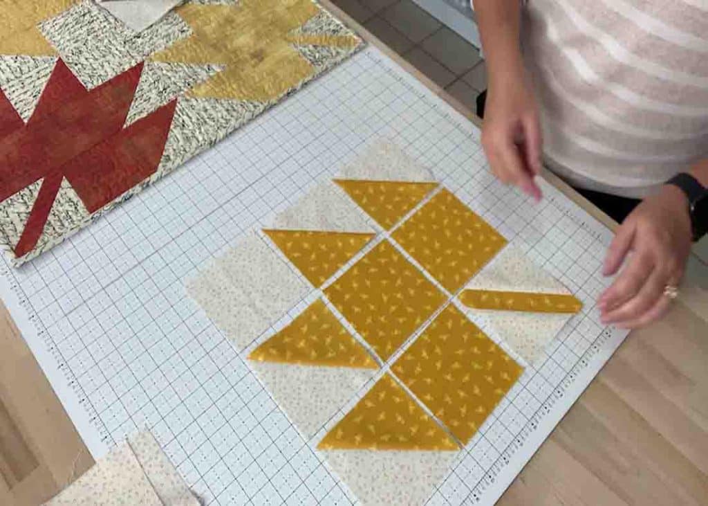 Laying out the maple leaf parts to create the quilted table topper