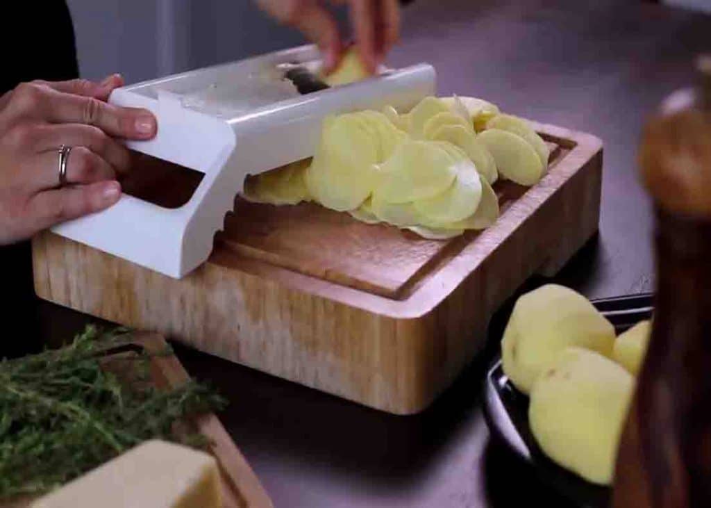 Slicing the potatoes thinly
