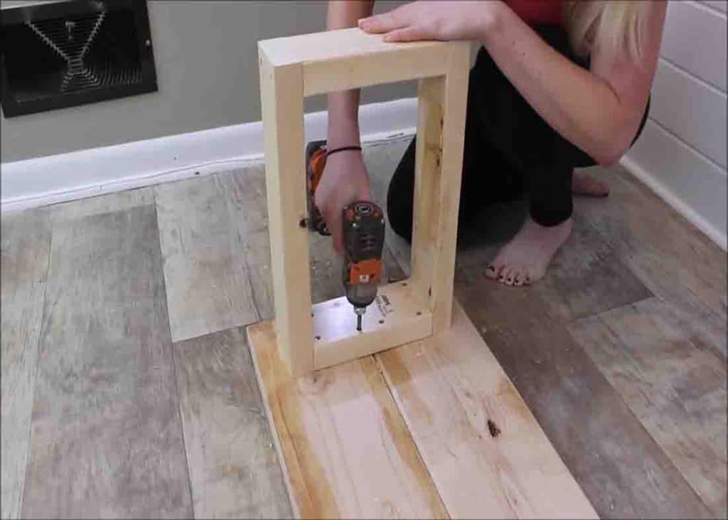 Attaching the legs of the DIY $15 bench
