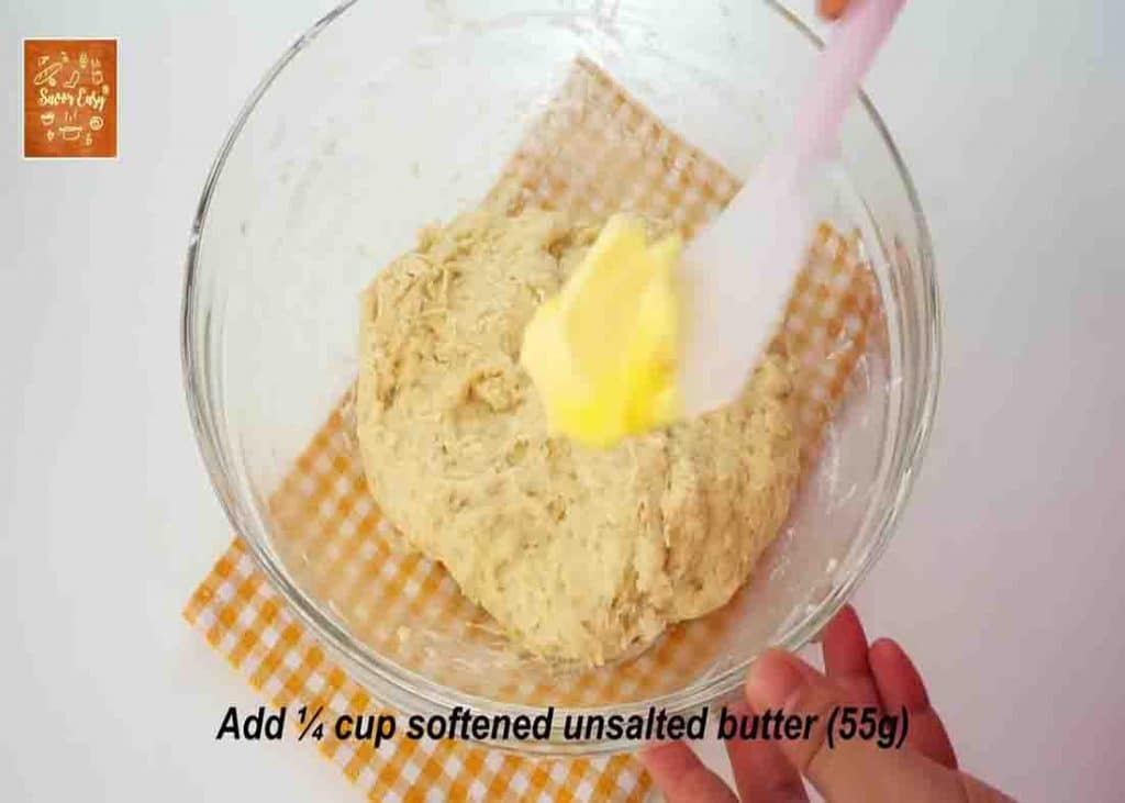 Adding butter to the cream cheese bread dough mixture