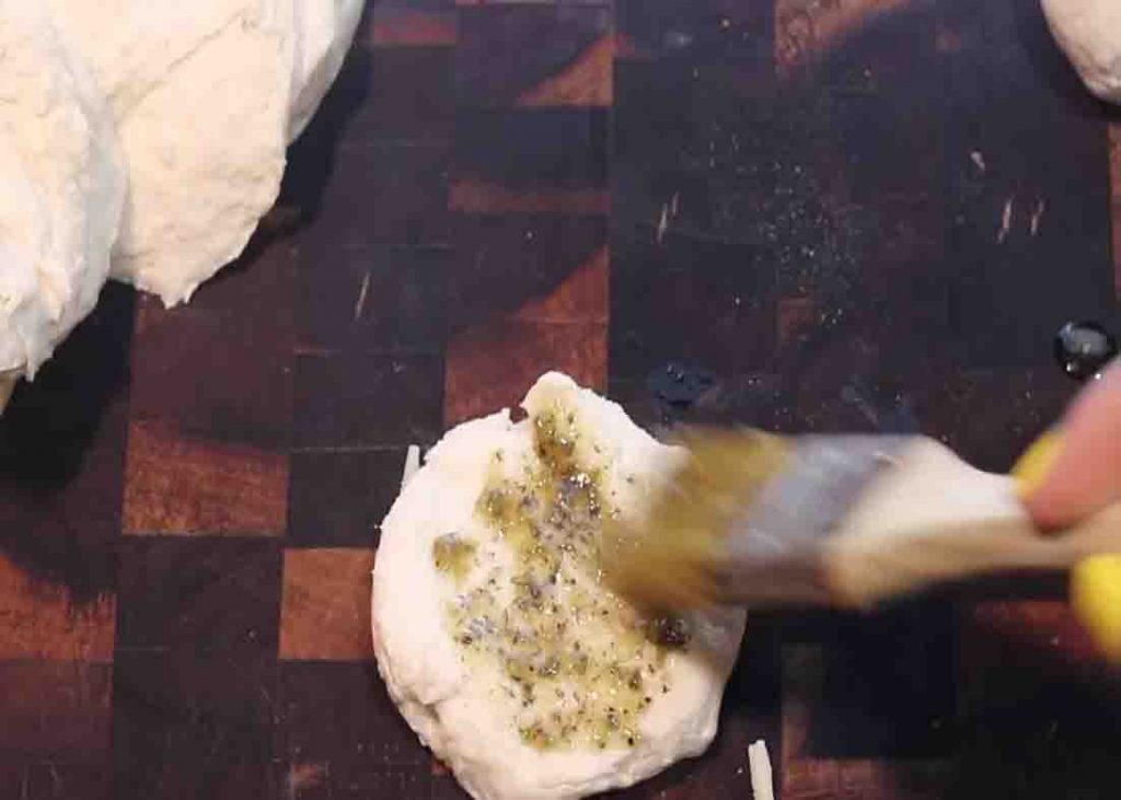Brushing the biscuit with some garlic butter mixture