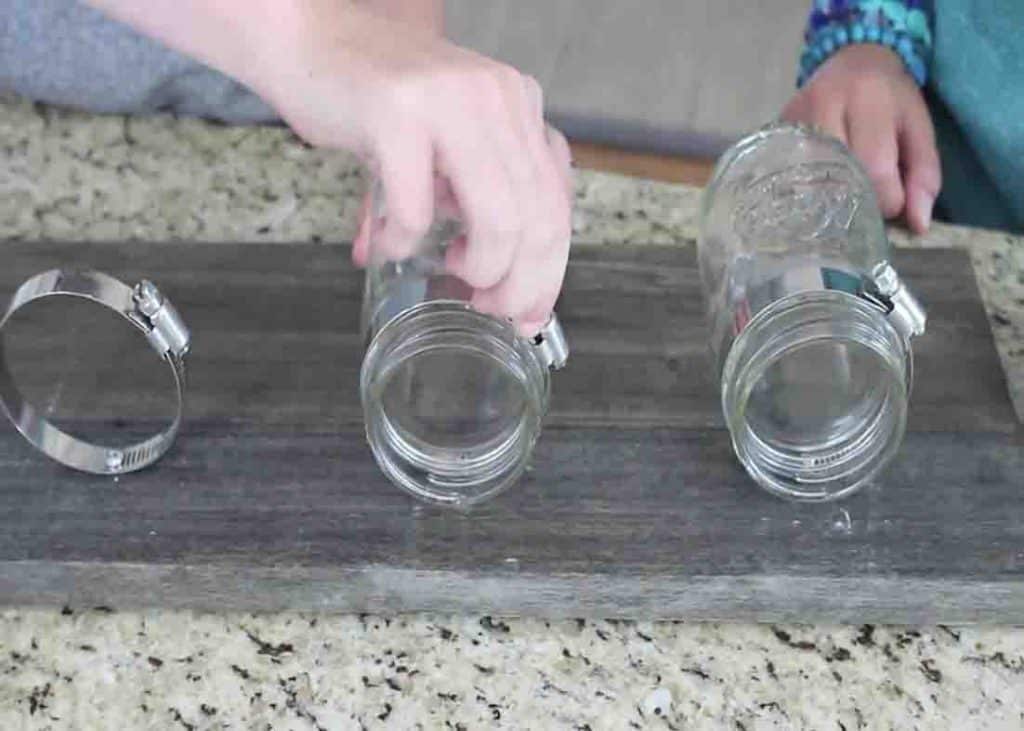 Attaching the mason jars to the wood