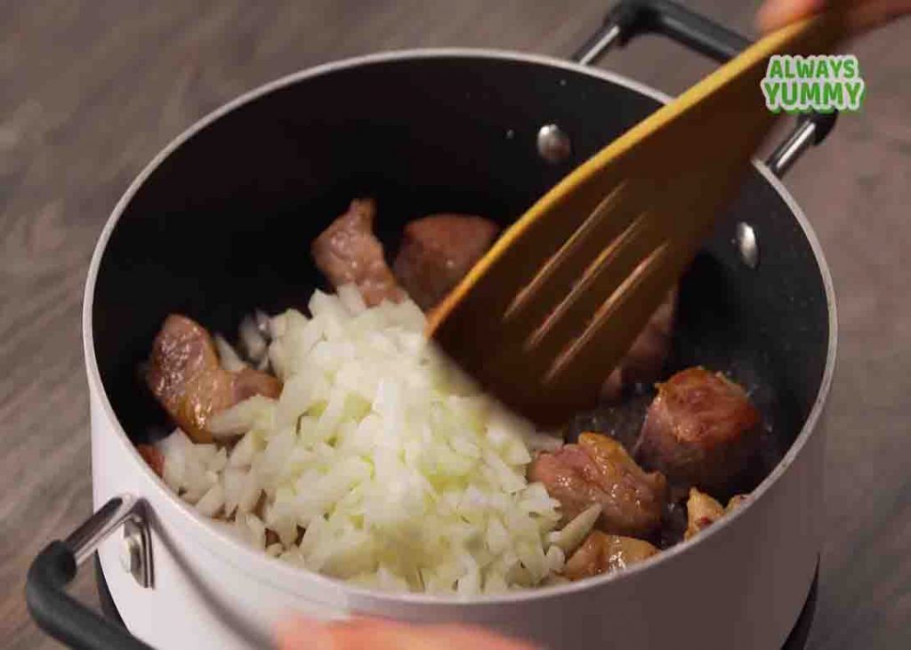 Sauteing the pork and onion for the pork stew recipe