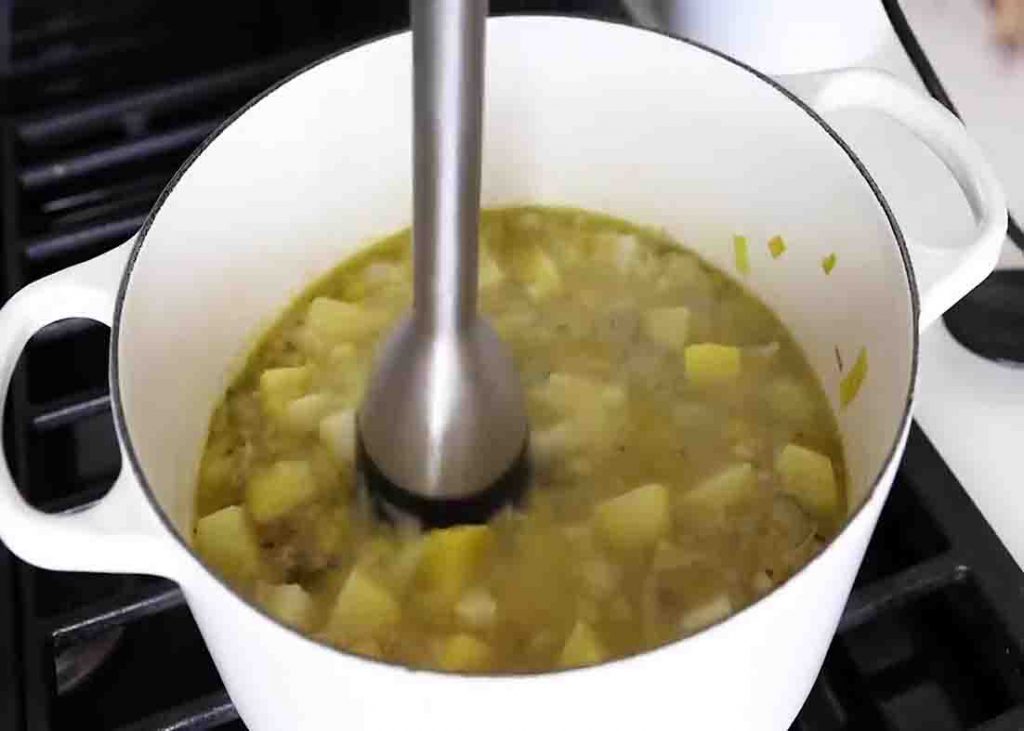Blending the potato leek soup to make it thick