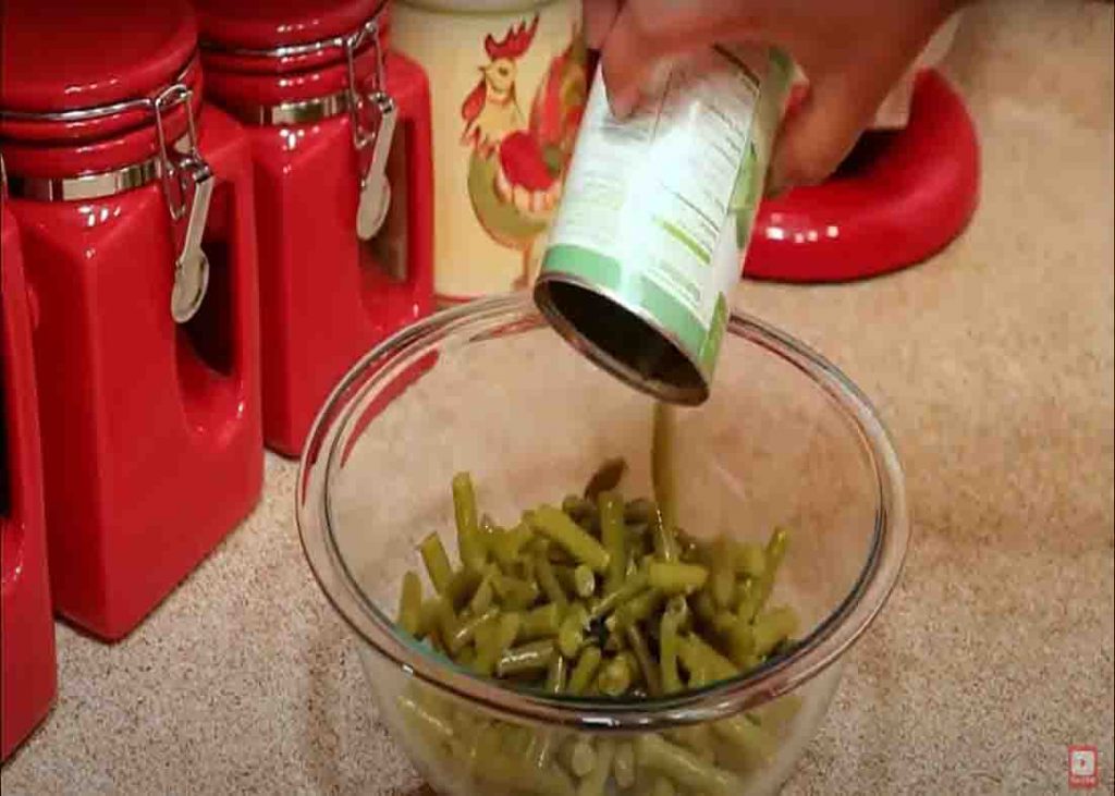 Adding the green beans to the bowl