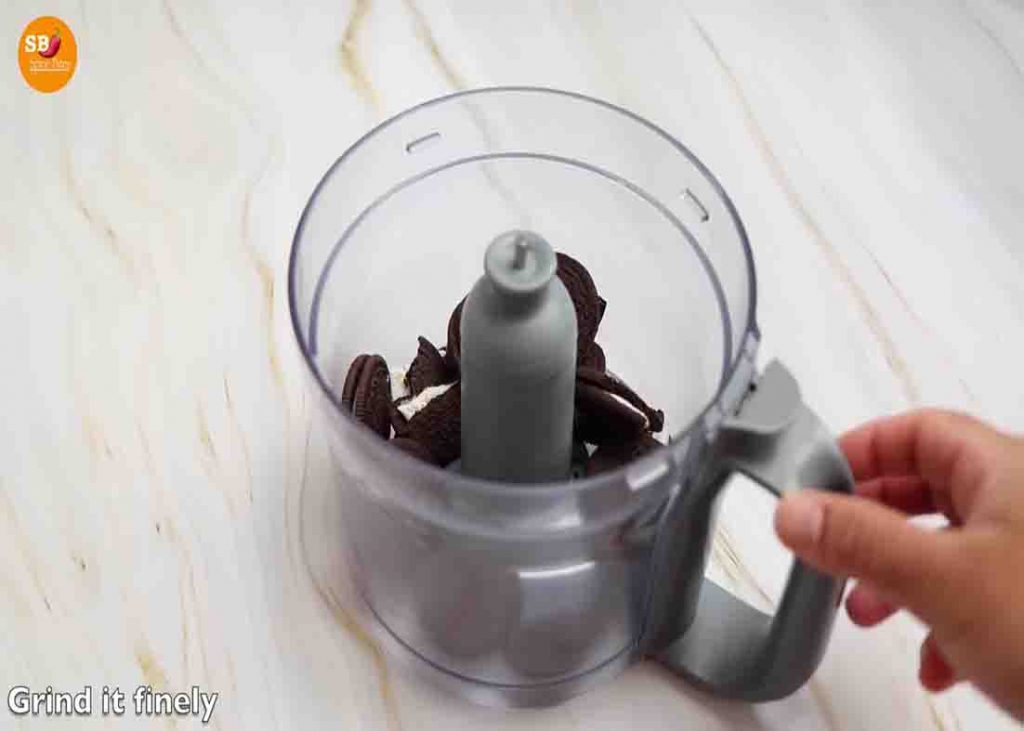 Grinding the Oreo biscuits for the base of the Oreo chocolate mousse cake