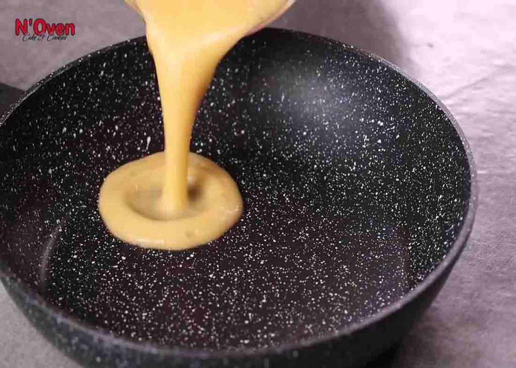 Pouring the pineapple puree to the pan to heat it