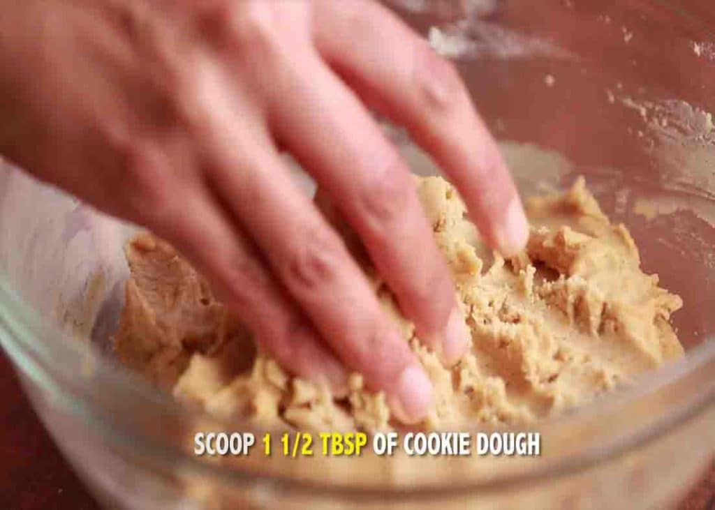 Scooping the dough to form the pumpkin snickerdoodle cookies