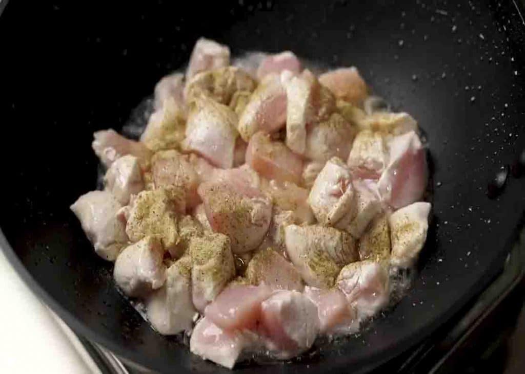 Stir frying the chicken pieces