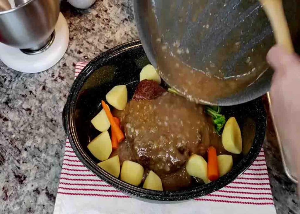 Pouring the gravy over the pot roast
