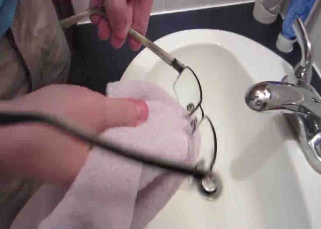 Wiping your glasses dry using a towel