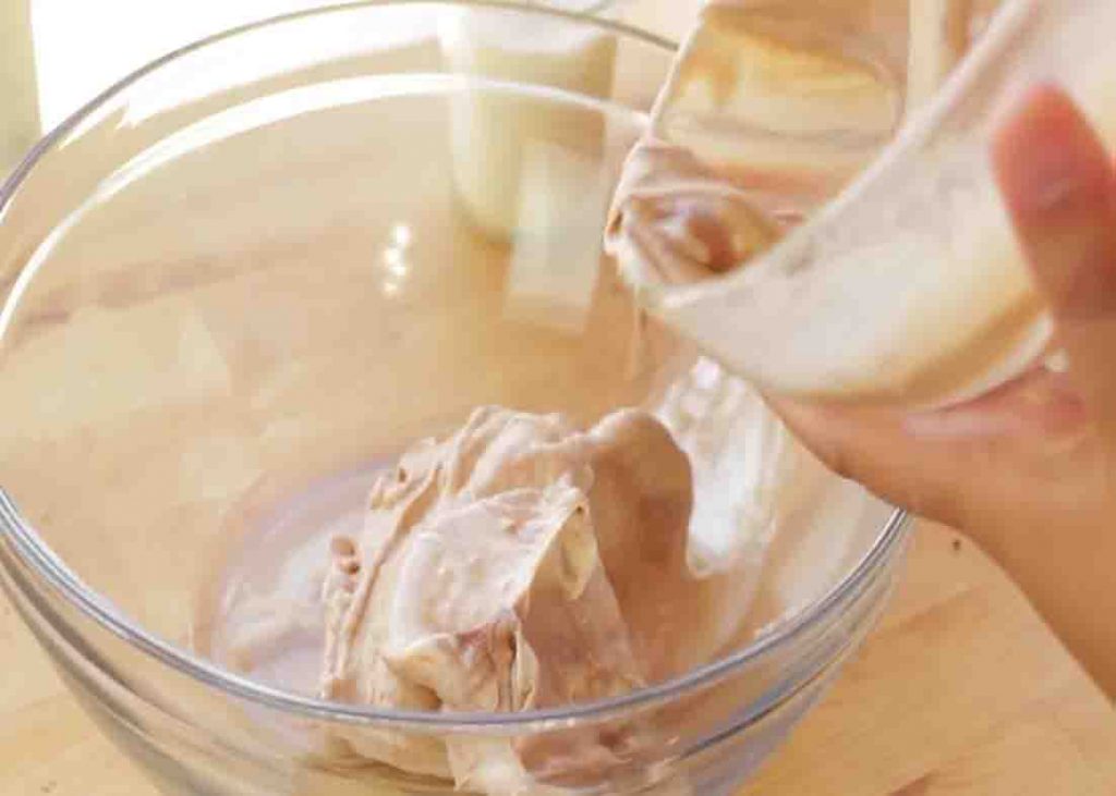 Adding the ice cream to a bowl for the 2-ingredient bread recipe