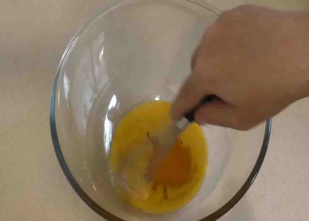Mixing the egg yolks for the honey souffle recipe