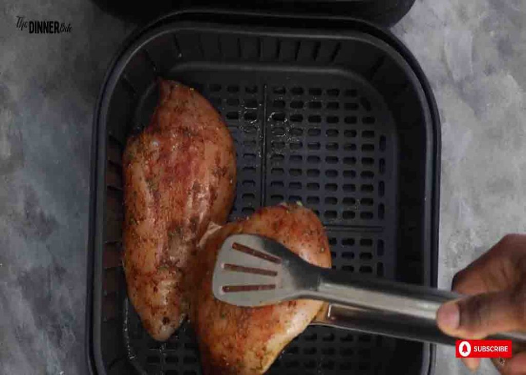 Placing the chicken breasts in the air fryer basket