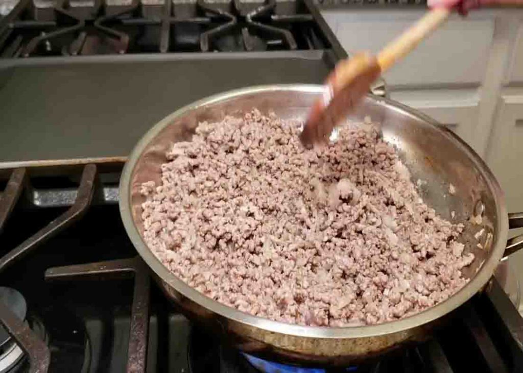 Cooking the ground beef for the cheesy baked enchiladas