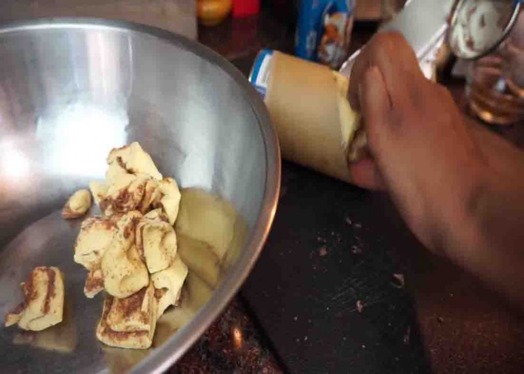 Cutting the cinnamon roll into six equal pieces