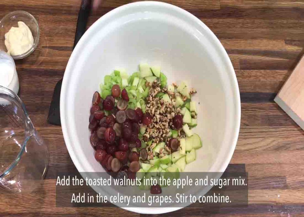 Combining all the Waldorf salad ingredients in a bowl