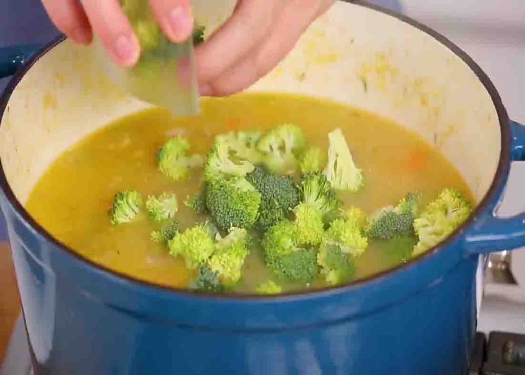 Adding the broccoli to the chicken soup