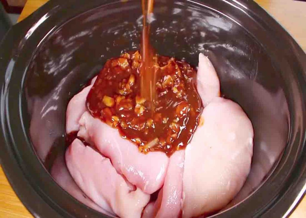 Pouring the sauce over the Hawaiian chicken