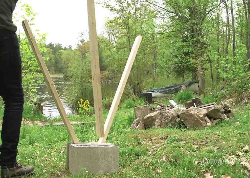 Assembling the cinder blocks and 2x4s to make the DIY firewood holder