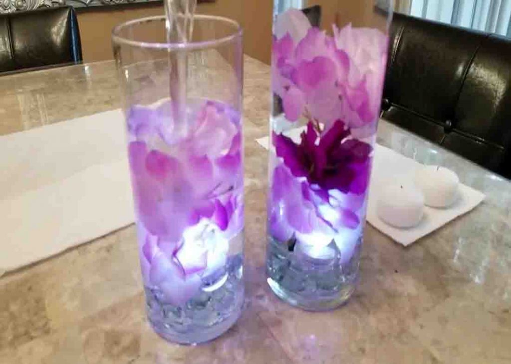 Filling the DIY dollar tree centerpiece with water