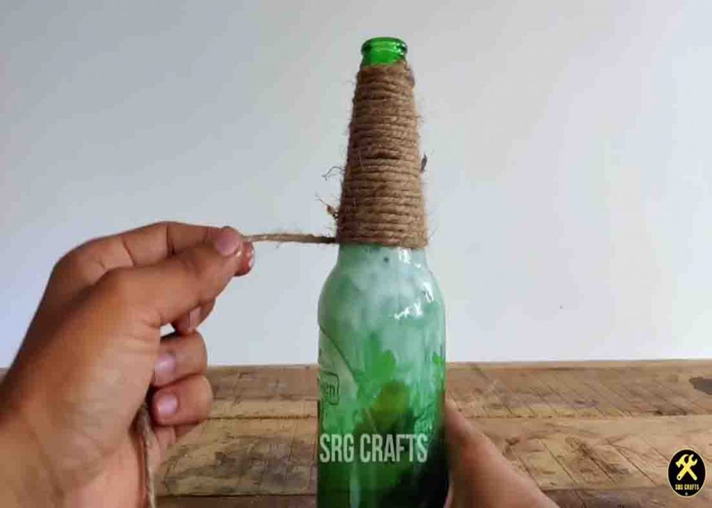 Wrapping some jute threads around the wine bottle for the hanging lamps