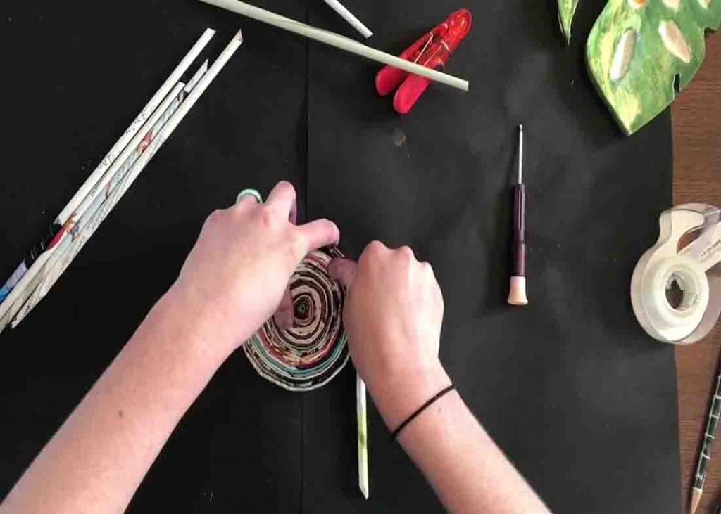 Coiling the paper straws to make the DIY magazine bowl