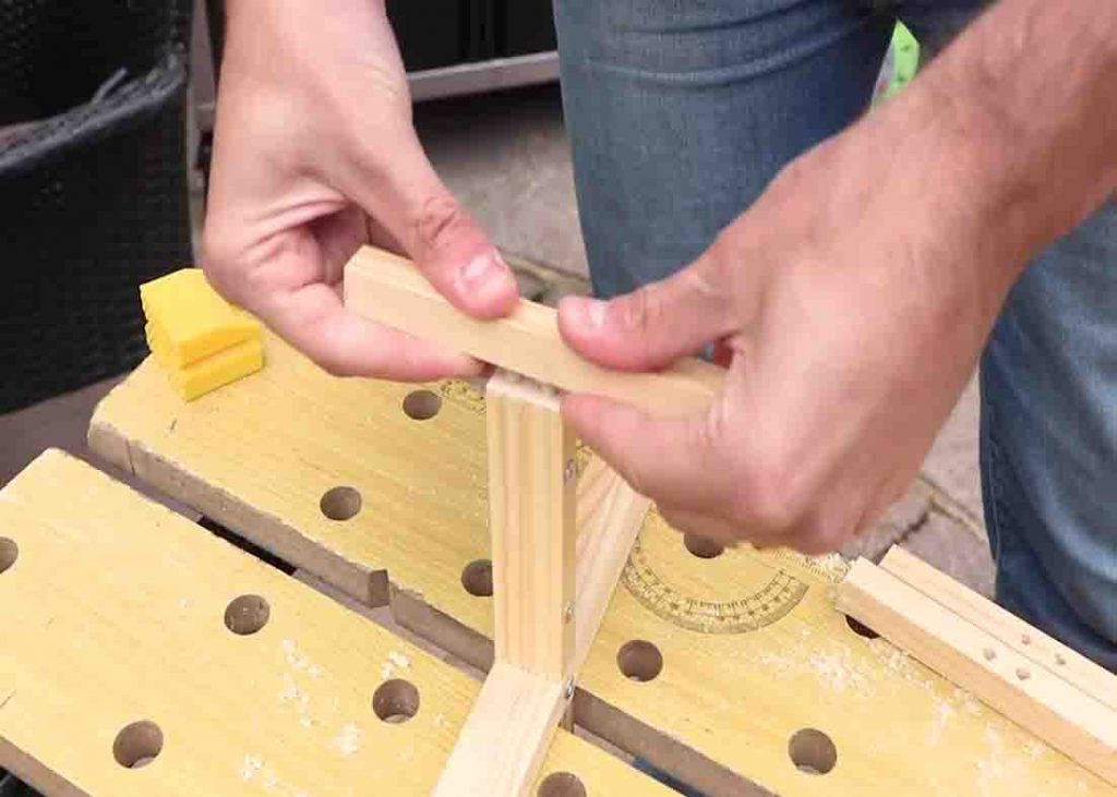 Attaching the stand of the wooden pot plant stand