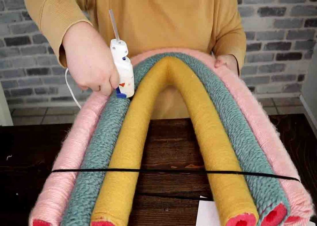 Gluing the pool noodles together with hot glue