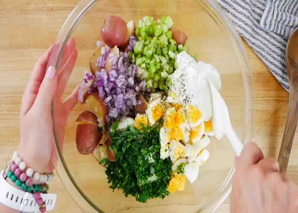 Folding all the potato salad ingredients together