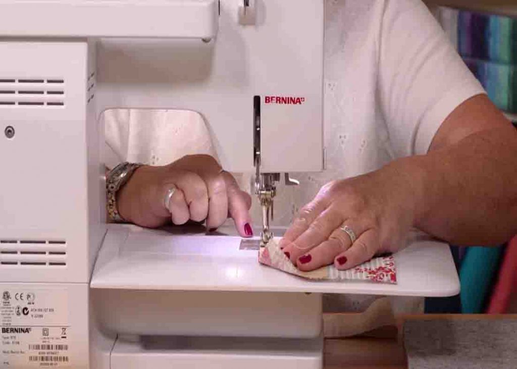 Sewing the charm pack strips together to make the quilt block