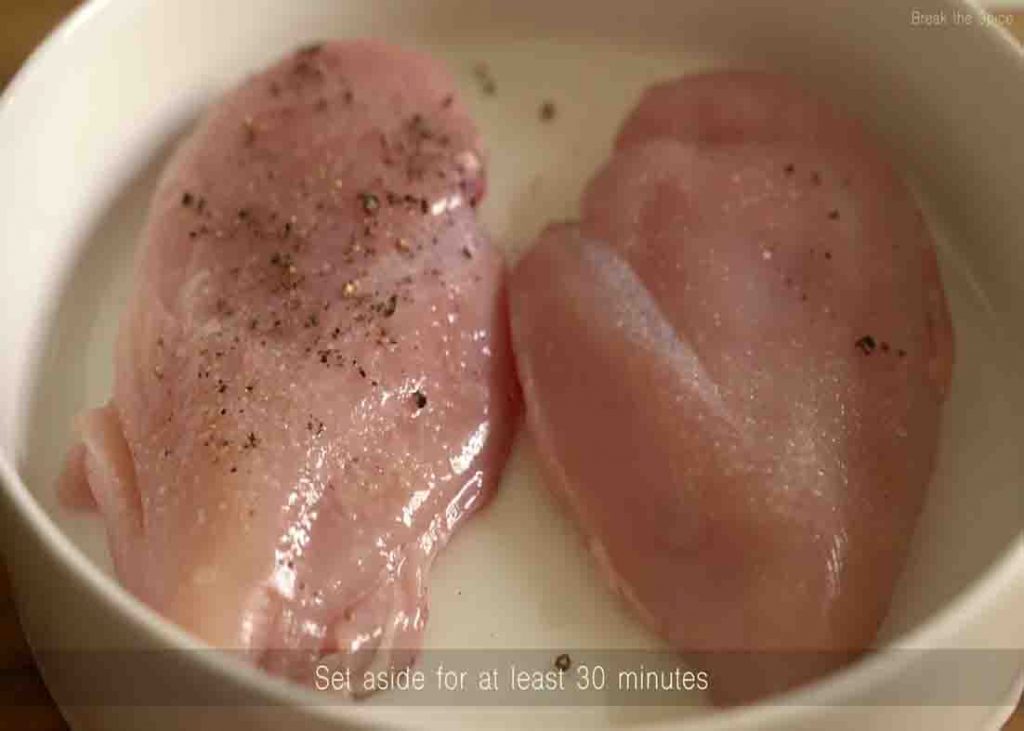 Seasoning the chicken breasts for the creamy garlic chicken recipe