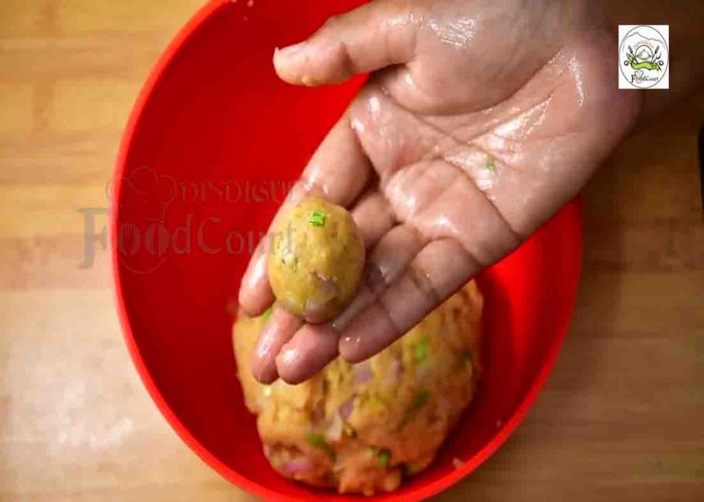 Rolling the potato mixture to make the potato lollipops