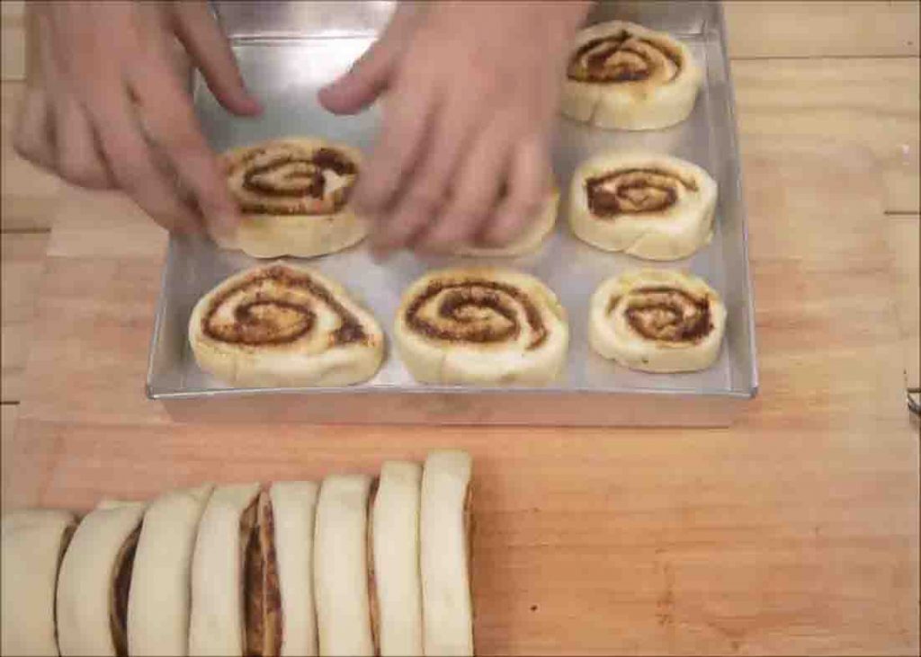 Placing the cinnamon rolls on the baking pan