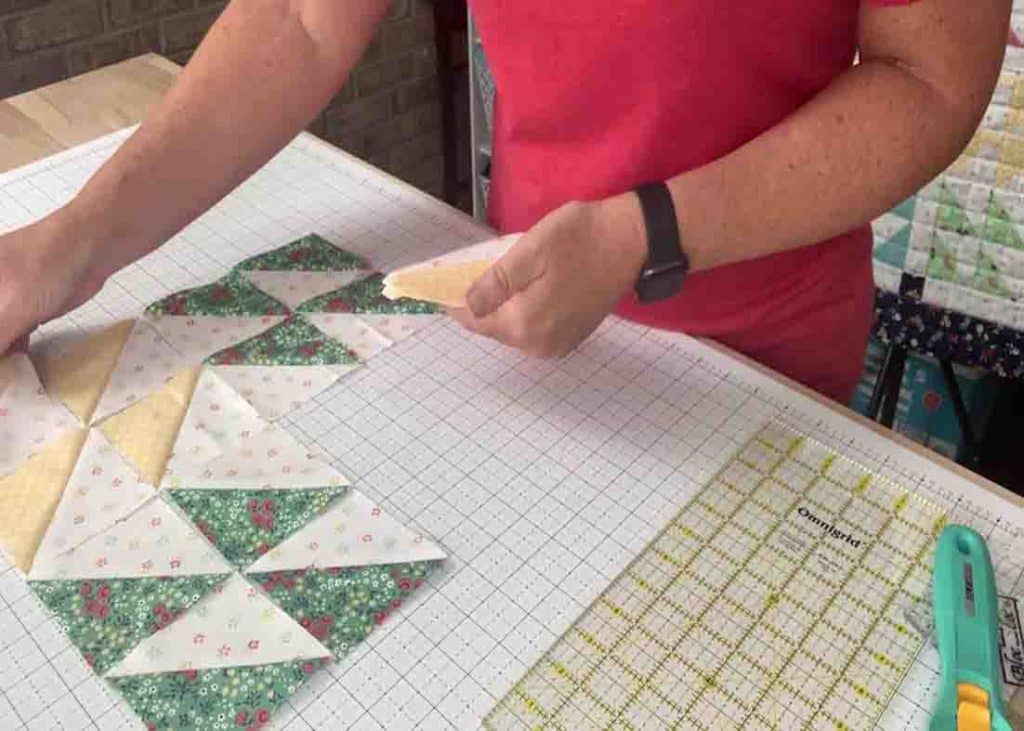 Laying out the kaleidoscope windows blocks to make the quilt top