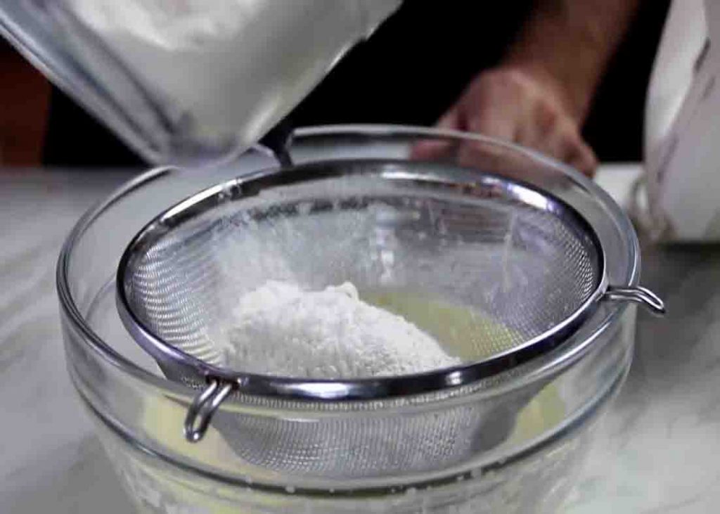 Sifting the flour for the one-bowl strawberry cake