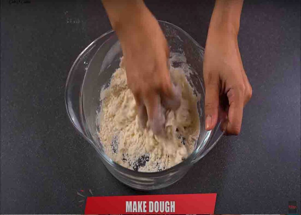 Folding the flour to make the dough for the potato roll samosa