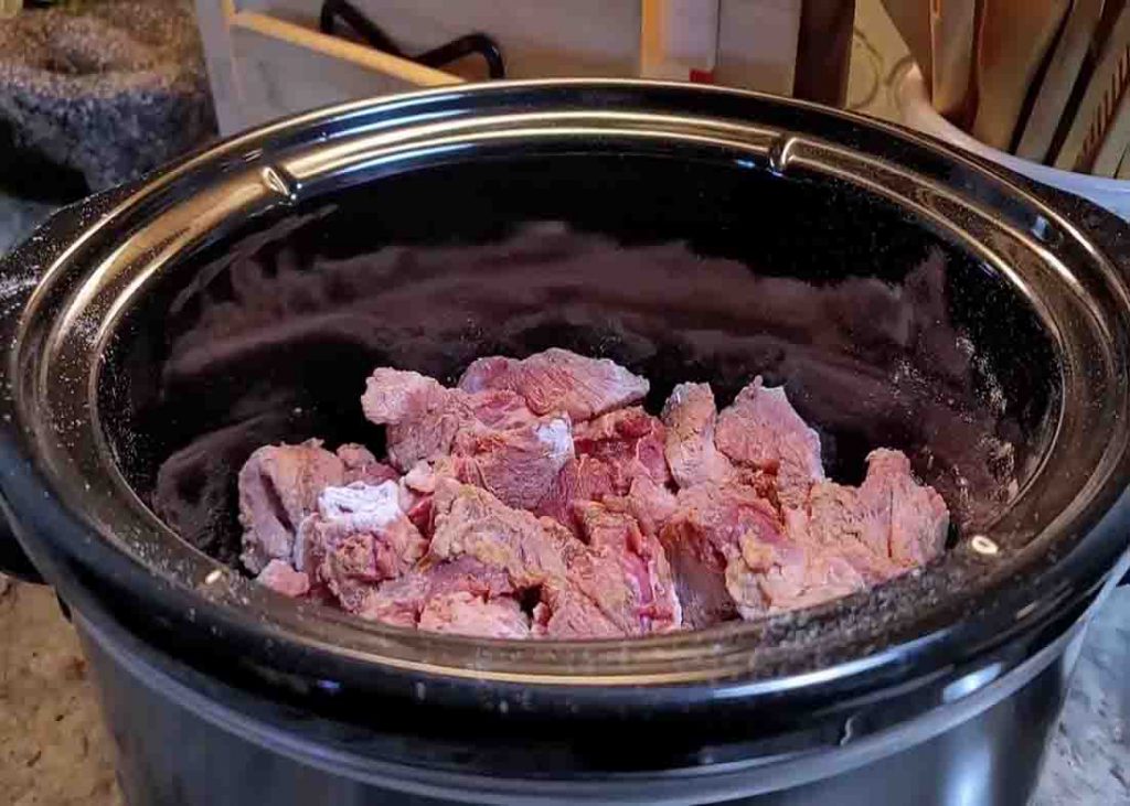 Adding the beef chuck to the slow cooker