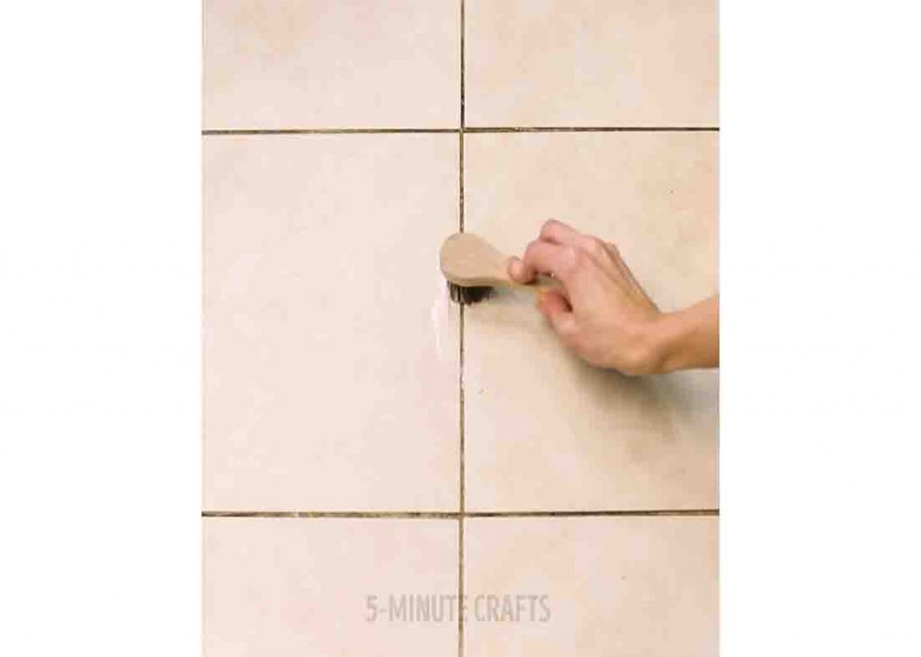Brushing the grout with the homemade solution