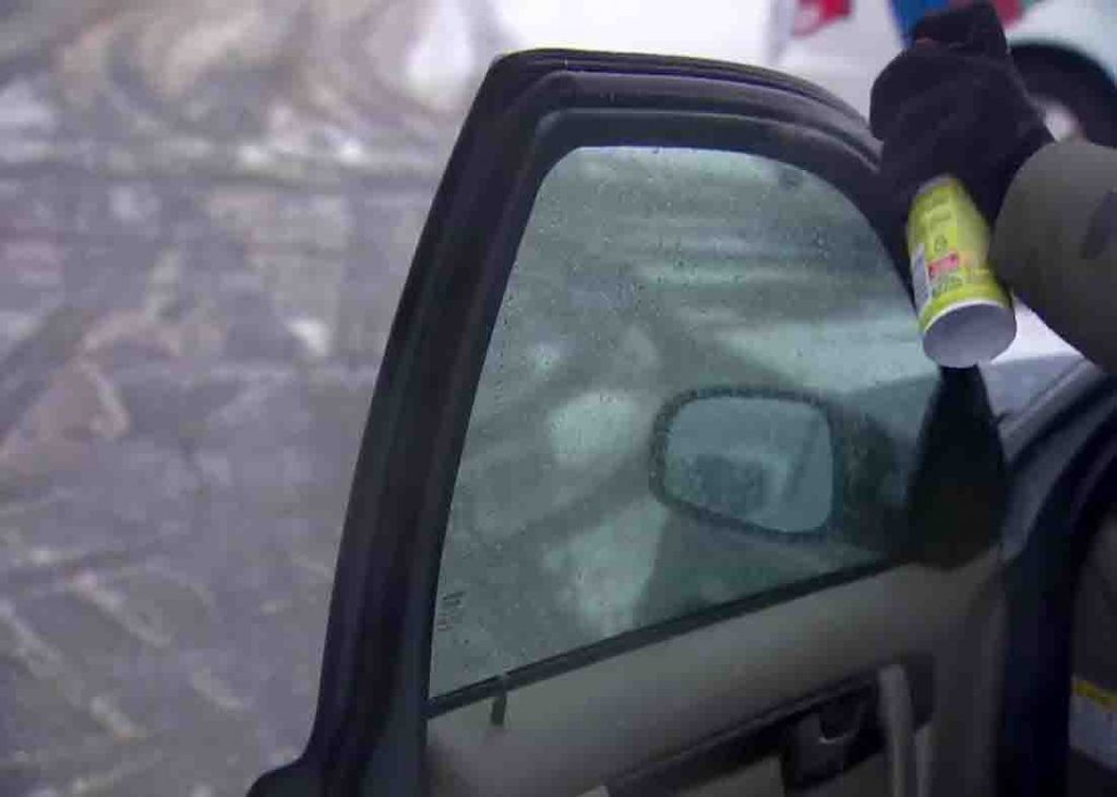 Spraying oil to the sides of your car door to prevent it from freezing