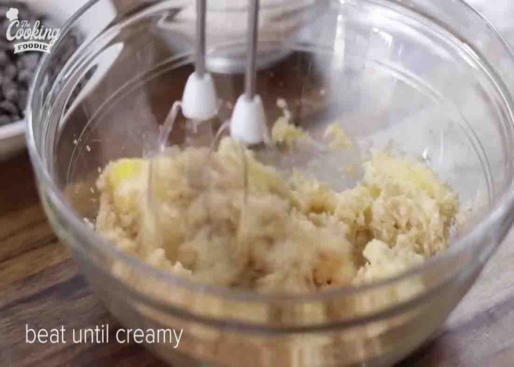 Beating the ingredients to make the chewy cookies